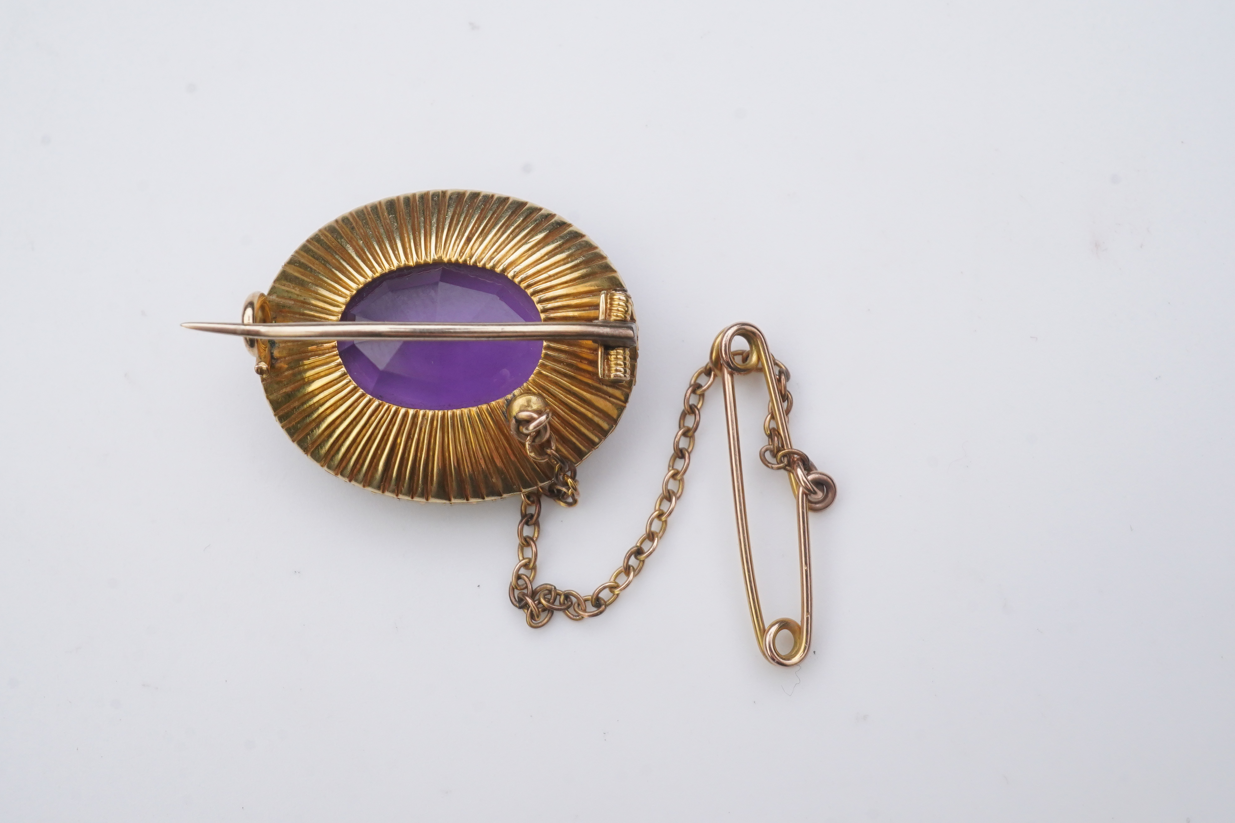 An amethyst and split pearl brooch, circa 1900